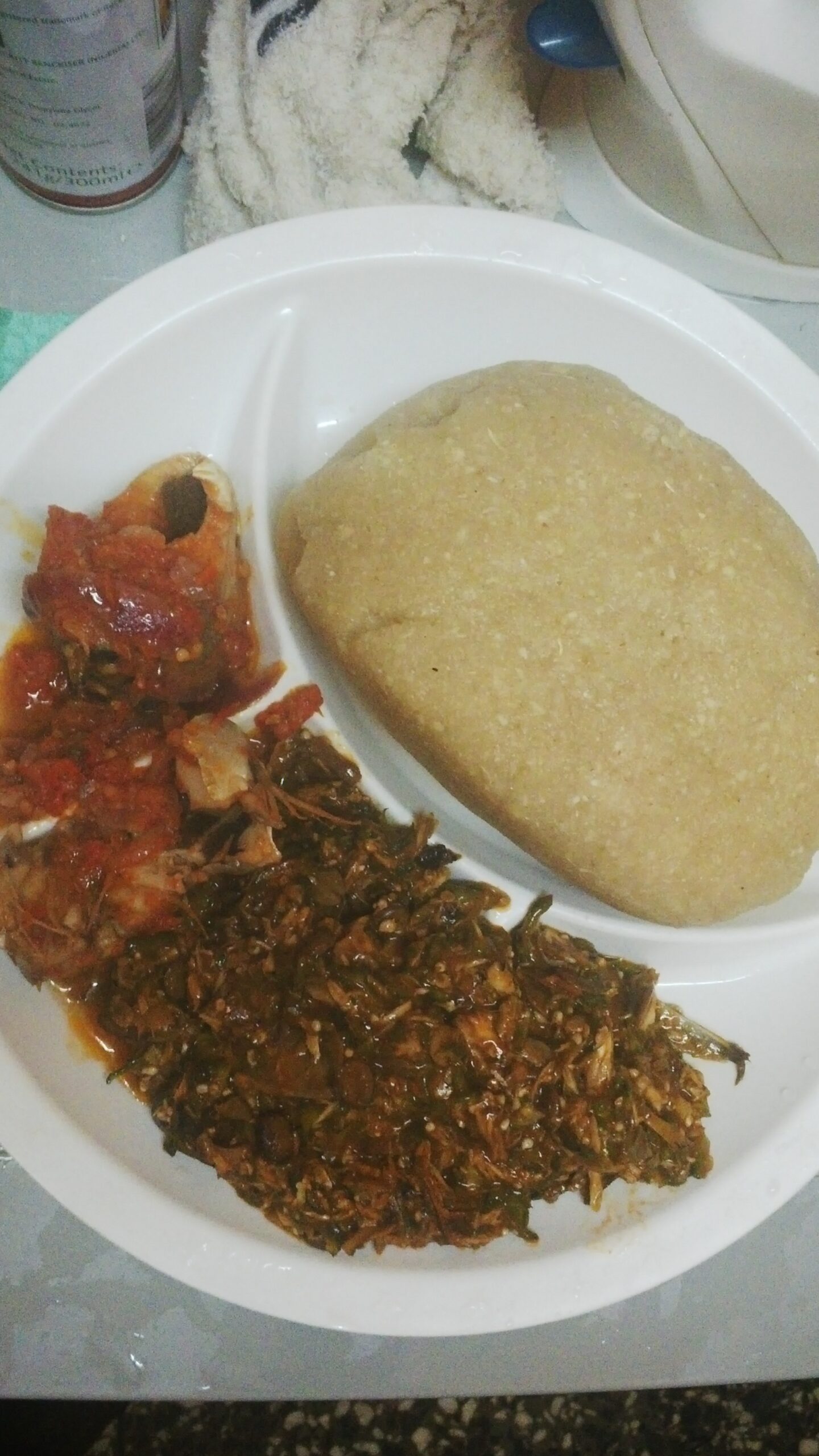 Eba served with Efo Riro vegetable soup and fish